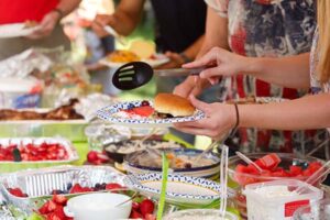 people filling their plates at a cookout celebration